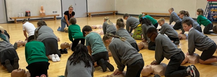 Pupils practicing CPR in workshop